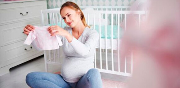 Mamá mirando la ropa de su niña arcoíris.